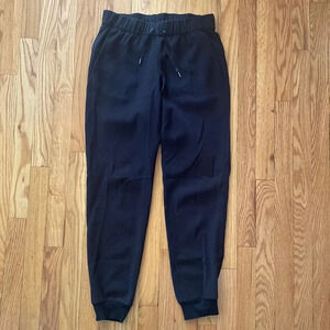 Lululemon On The Fly Pant *28" black pockets elastic waist + tie stretch ankle